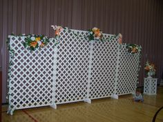 the room is decorated with flowers and white fencing