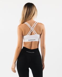 HIGHLIGHTS. Custom fabric blend made from our fine Italian yarn. Top finish treatments to achieve buttery softness. Unique filament count - allows extreme stretch and wicking capabilities. Scoop neckline. Medium support. ForeverKnit logo on waistband FIT SUGGESTION. This item runs true to Alphalete’s standard seamless fit.. If you are between sizes, we recommend sizing up.. Model is 5’8”/172cm, wearing a size XS with a 31”/78cm bust. MATERIALS AND WASHING DIRECTIONS. 51% Polyamide, 38% Polyester White High Stretch Elastane Sports Bra, White Medium Support Activewear In Elastane, White Activewear With Medium Support, White Elastane Activewear With Medium Support, White Fitted Seamless Activewear, Fitted White Seamless Activewear, White Seamless Activewear For Gym, White Seamless Fitted Activewear, Fitted White Sports Bra In Elastane