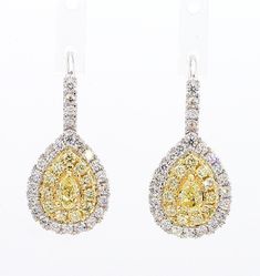 RareGemWorld's classic diamond earrings. Mounted in a beautiful 18K Yellow and White Gold setting with natural pear cut yellow diamonds. The yellow diamonds are surrounded by small round natural white diamond melee and small round natural yellow diamond melee. These earrings are guaranteed to impress and enhance your personal collection! Total Weight: 1.53cts   Length x Width: 23.8 x 10.8 mm Center Diamond Measurements: 5.0 x 3.0 mm Side Diamond Measurements: 1.5 - 1.7 mm  Natural Pear-Cut Yello Classic Diamond Earrings, Yellow Diamonds, White Gold Set, Pear Diamond, Gold Drop Earrings, Yellow Diamond, Pear Cut, White Diamonds, White Diamond