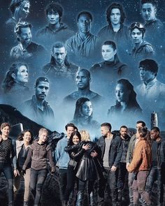 a group of people standing next to each other in front of a star wars poster