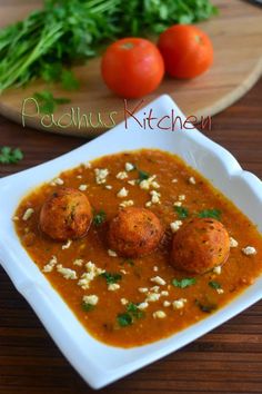 some food is in a white bowl on a table next to tomatoes and parsley