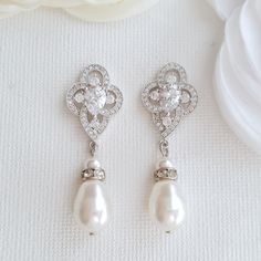 Elegant Mabel pearl drop bridal earrings are made with a central teardrop shaped cubic zirconia surrounded with tiny shiny cz crystals in a victorian style with a soft sheened pearl drop. All material used is rhodium plated brass. Pearls used in the picture are white/lt ivory. Light weight on the ears.# length of Earring from top is approx 1.5 inches or 4 cms Pearl Drop Bridal Earrings, Silver Pearl Drop Earrings, Drop Bridal Earrings, Crystal Wedding Earrings, Pearl Wedding Jewelry, Drop Earrings Bridal, Pearl Drop Earrings Bridal, Teardrop Pearl Earrings, Silver Bridal Earrings