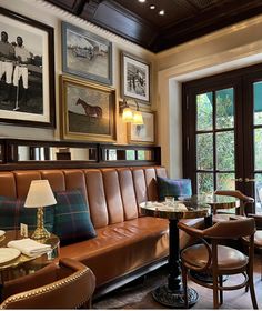 a living room filled with furniture and pictures on the wall