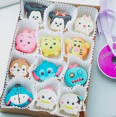 there are many cupcakes in the box and one is decorated with an owl