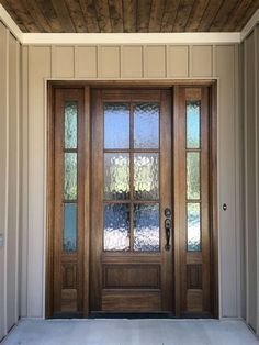 a wooden door with glass panels on the side