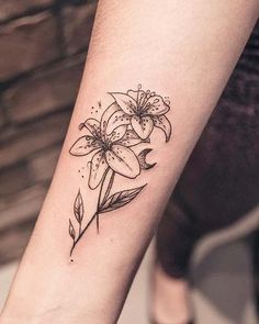 a woman's arm with a flower tattoo on it