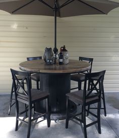 a table with chairs and an umbrella over it