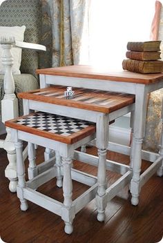 two tables with chess pieces on them in front of a window