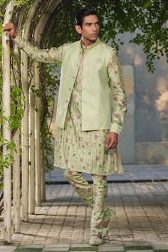 Mint green sleeveless Nehru jacket with stitchline thread embroidery in stripe pattern. Paired with floral print pleated kurta and churidar. - Aza Fashions Green Fitted Kurta With Stand Collar, Festive Green Outerwear With Stand Collar, Fitted Green Bandhgala For Spring, Spring Green Fitted Bandhgala, Fitted Green Nehru Jacket For Spring, Green Fitted Nehru Jacket For Spring, Green Sleeveless Fitted Nehru Jacket, Festive Green Nehru Jacket With Stand Collar, Traditional Green Nehru Jacket For Spring