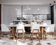 a dining room table with white chairs around it