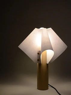 a lamp that is on top of a wooden pole with a light bulb in the middle