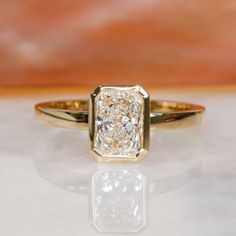 a close up of a diamond ring on a table