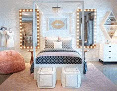 a white bed with lights on the headboard and foot stools in front of it