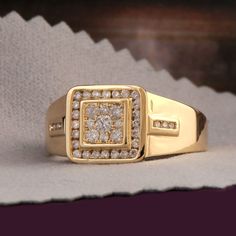 a gold ring with white diamonds on it sitting on top of a piece of paper