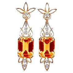 Transport yourself to the glamorous Retro era with these vintage-inspired earrings that exude undeniable charm and elegance. The focal point of each earring is a magnificent emerald-cut citrine, with the first weighing 9.11 carats and the second weighing 8.45 carats. These vibrant citrines, reminiscent of sunshine, are expertly set within an intricate floral openwork design crafted in 18k yellow gold. Adding a touch of brilliance and sophistication, vertical rows of round brilliant cut diamonds Estate Diamond Jewelry, Vintage Inspired Earrings, Retro Era, Citrine Earrings, Aquamarine Engagement Ring, Fancy Diamonds, Citrine Stone, Wedding Jewelry Earrings, Gold Floral