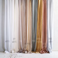 four different colors of curtains hanging on a white wall with the words off written below them