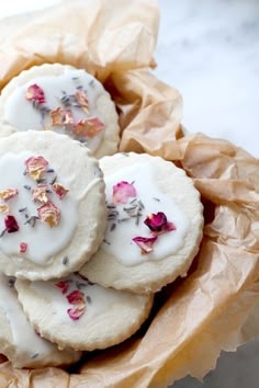 some cookies with white icing and flowers on them