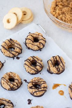 chocolate covered donuts with peanut butter on top and oatmeal toppings