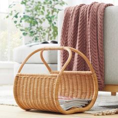 a basket sitting on the floor next to a couch