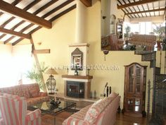 a living room filled with furniture and a fire place