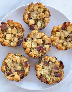 several small muffins on a white plate