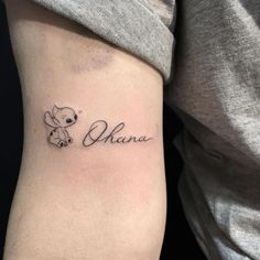 a woman's arm with a small tattoo on it that says, ohana