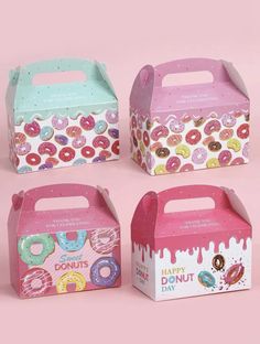 four boxes with donuts painted on them and one is pink, the other is blue