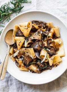 a white bowl filled with pasta and mushrooms