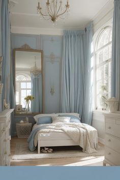 a bedroom with blue walls, white furniture and a chandelier hanging from the ceiling