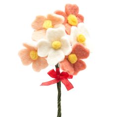 a bouquet of flowers with a red ribbon tied around the end and two white petals on top