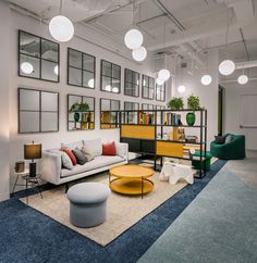 a living room filled with furniture and lots of mirrors on the wall next to each other