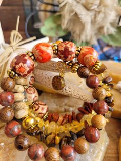 Boho/Hippie Style Bracelet. Made with Gold Memory Wire, Multi Colored Glass Beads ,Natural Colored Beads, Citrine Chip Beads, Gold Antiqued Spacer Beads, Red Jasper Chip Beads, Multi Colored Orange/Jasper Beads with Flower Design, Tiger Eye Chip Beads, Golden Tree Charm on one end Boho Beads, Boho Style Bracelets, Boho Hippie Style, Golden Tree, Chip Beads, Bead Bracelets, Jasper Beads, Memory Wire, Red Jasper