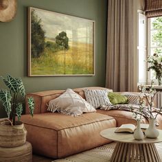 a living room filled with furniture and a painting hanging on the wall above it's coffee table