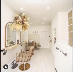 the interior of a hair salon with chairs and mirrors