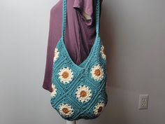 Brighten your summer with our charming Floral Daisy Granny Square Crochet Bag! Perfect for sunny days and beach outings, this handmade purse adds a splash of joy to any outfit. Why You'll Love It: - Handmade Quality: Each bag is crafted with love, ensuring a unique and high-quality accessory.  - Unique Design: Features a vibrant floral pattern and granny square style that stand out from mass-produced bags. - Personalized Touch: Customize with your favorite colors to make it truly yours.  - Suppo Bohemian Crochet Bag For Beach Season, Green Crochet Beach Bag For Vacation, White Bohemian Crochet Bag For Summer, Green Crochet Beach Bag, Handmade Green Crochet Bag For Summer, Multicolor Crochet Beach Bag, Bohemian Crochet Beach Bag, Multicolor Crochet Beach Bag For Summer, Crochet Bag For Daily Use In Summer