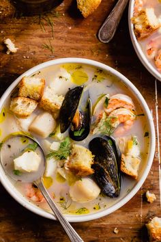 a bowl of seafood soup with bread on the side and text overlay that reads light & flavorful seafood soup