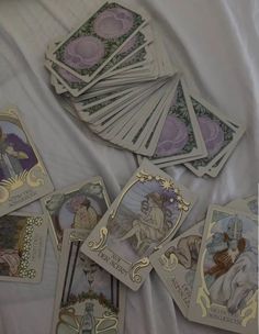 there are many different cards on the bed together, including one with an angel in it