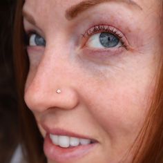 a close up of a woman with blue eyes