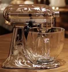 a glass mixer sitting on top of a wooden table