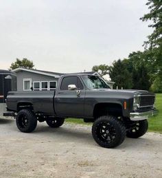 a gray truck parked in front of a trailer