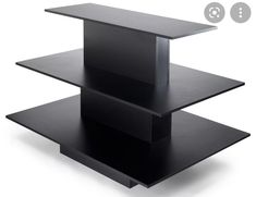 three tiered black shelf on white background