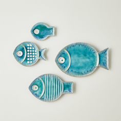 three blue ceramic fish sitting next to each other