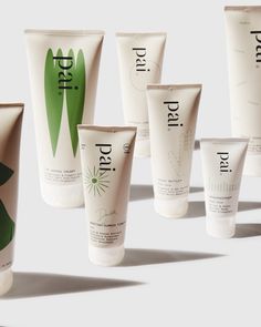 several different types of hand creams are arranged in a row on a white surface