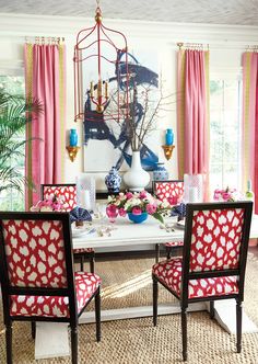 the dining room is decorated with pink, blue and white accessories for an elegant touch