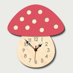 a clock with a red mushroom on the top and white dots around it's face