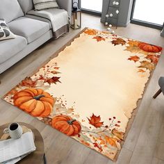 a living room with a rug that has pumpkins on it and leaves around the edges