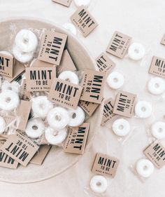 mini donuts are sitting in a bowl on a table with small tags around them