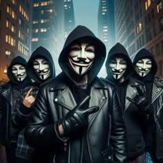 a group of masked people standing in front of tall buildings wearing black leather jackets and hoods