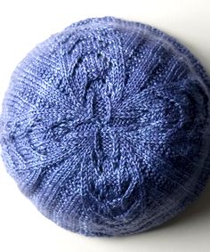 a blue ball of yarn sitting on top of a white table