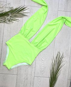 "FREE SHIPPING TO USA FOR ALL ORDERS OVER 35$! Choose right size by following our size chart below, thank you! We use FEDEX PRIORITY shipping service to the United States to guarantee the fastest delivery in 3-4 days. Flattering one piece swimsuit in neon green fabric with open back and high cut. It has a deep neckline secured at the back of the neck with a halter tie. Stretchy and body fitting material. COLOR: NEON GREEN MEASUREMENTS: X-Small - Bust - 32\" - 34\" (82-86 CM) - Hips - 35\" - 36\" Green One-piece Bodysuit For Beach, Green One-piece Bodysuit For Beach Season, Green Stretch Bodysuit For Vacation, Green One-piece Bodysuit For The Beach, Green Stretch Bodysuit For Beach, Green Stretch Bodysuit For The Beach, Green Beachwear Bodysuit For Pool, Green Stretch Bodysuit For Poolside, Spring Green Bodysuit For Pool